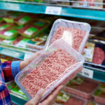 Buyer chooses minced meat in a store