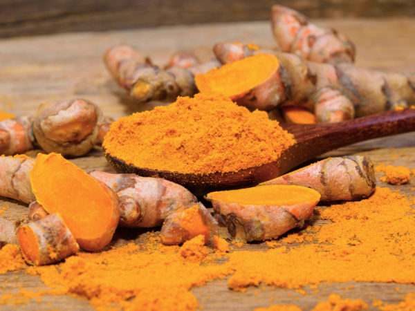 Sjögren's Syndrome fresh turmeric roots on wooden table