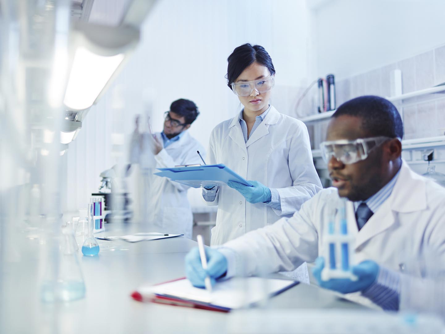 Young scientists analyzing substances in laboratory