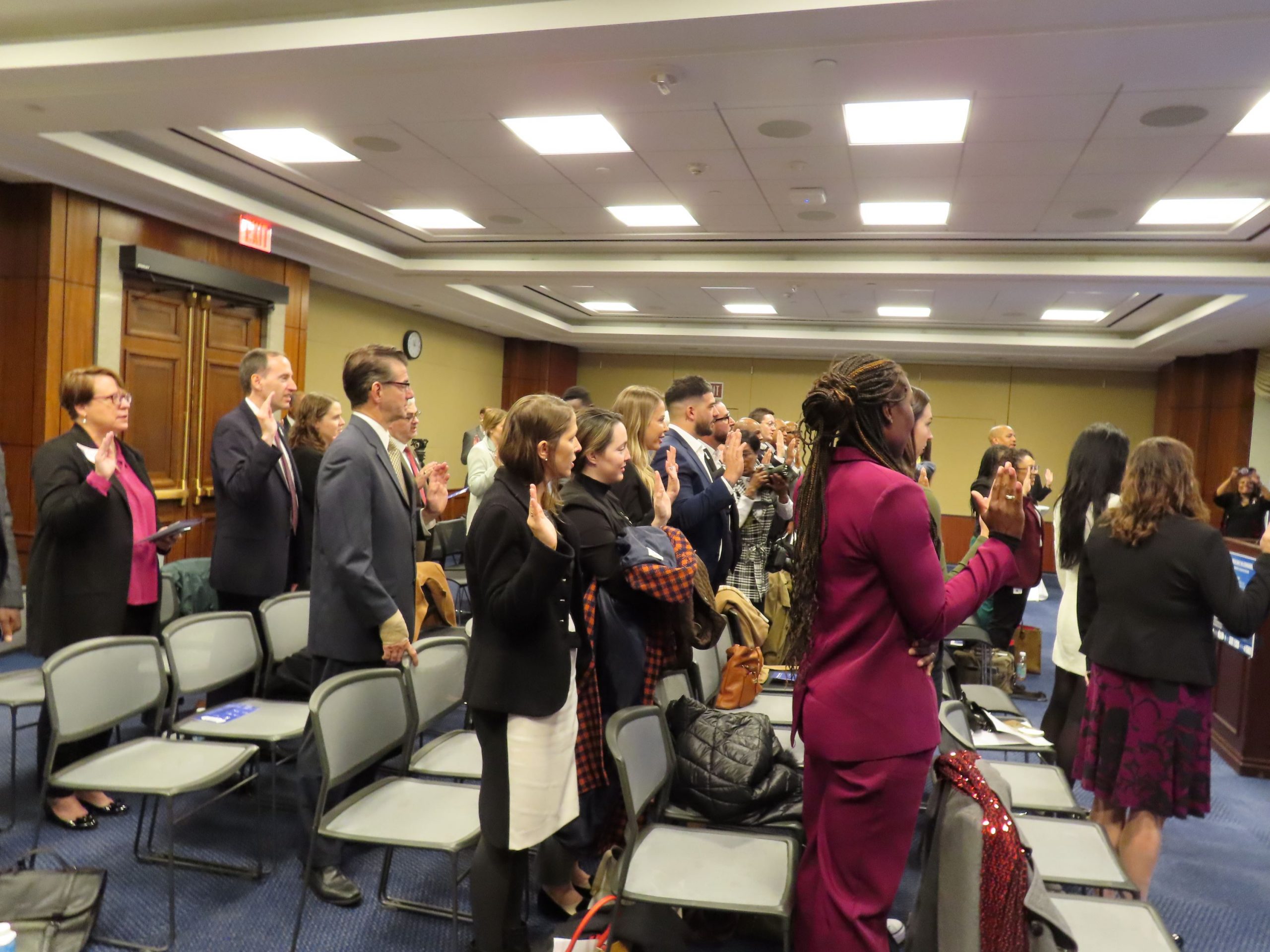 Attendees of the White Ribbon Day in Congress event on Dec. 1, 2023, take the White Ribbon pledge
